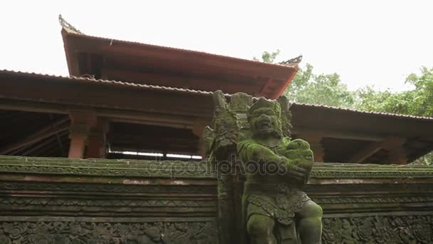 Statue of mythical animals. Mossy sculptures in Monkey forest. Ubud, Bali, Indonesia.