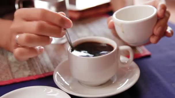 Woman adding coconut condensed milk in strong black coffee. Asian cuisine, traditional Asian method of brewing coffee. Cambodia. — Stock Video