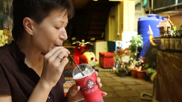 BANGKOK, THAILAND - 20 de outubro de 2013. Mulher bebe chá verde com chantilly. Mulher gosta de sua bebida fria . — Vídeo de Stock