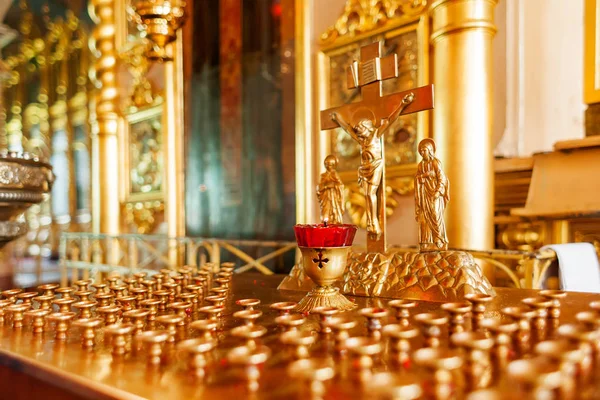 Gouden kandelaar in de orthodoxe kerk. Symbolische orthodoxe gouden kruis met de kruisiging van Jezus. — Stockfoto