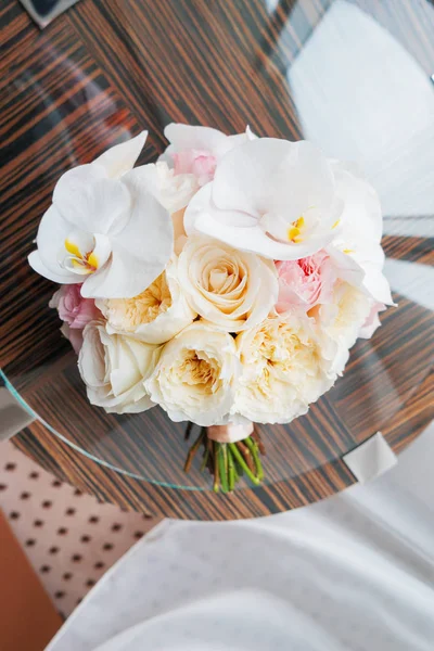 Bride's accessories - bouquet, floral composition with roses and orchids. Stock Photo