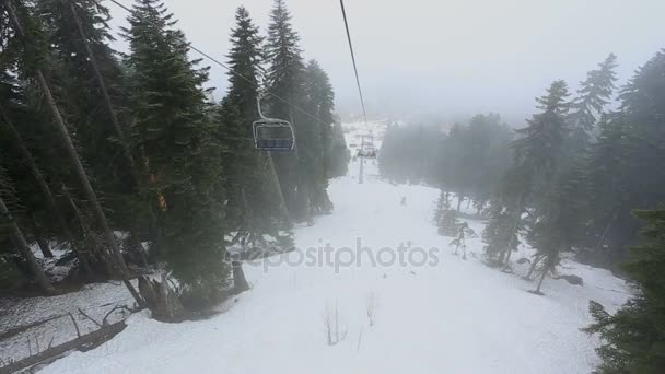 Tourists go in cabins on the ropeway through fog. Early morning trip above misty forest in Mestia, Georgia. — Stock Video