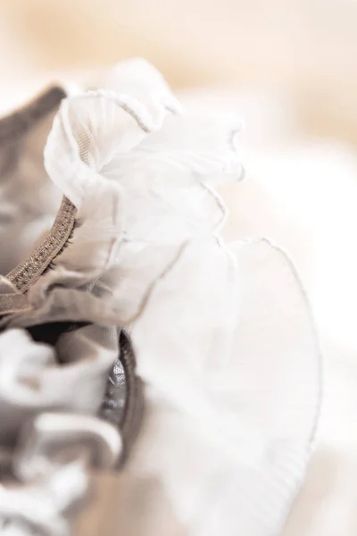 Bride's garter. Bride's traditional symbolic accessory. Grey laces with bows. Close up. — Stock Photo, Image
