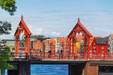 TRONDHEIM, NORWAY - July 15, 2017. Tourists walking on Gamle Bybro - The Old Town Bridge, also known as Lykkens Portal (Portal of Happiness). clipart