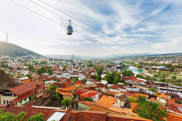 Vista panorámica de Tiflis, capital del país de Georgia. Vista desde la fortaleza de Narikala. Carretera de cable sobre techos alicatados . — Foto de Stock