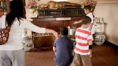 Bangkok, Tayland - 22 Ekim 2012. İnsanlar altın yatan Buda heykeli dua. WAT Saket Ratcha Wora Maha Wihan altın dağ .