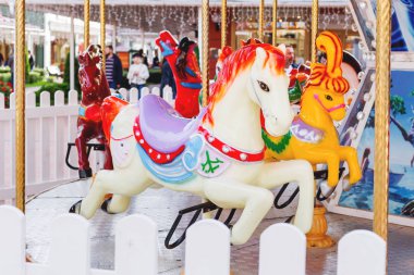 Carousel ile renkli çalışan atlar. Çocuk için şehir cazibe