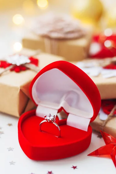 Fondo de Navidad y Año Nuevo con anillo de compromiso y regalos, decoraciones para árbol de Navidad. Fondo de vacaciones con estrellas confeti y bombillas . — Foto de Stock