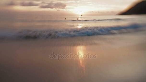 Mensen zwemmen in zee. Seasurf op zonsondergang in Nai Harn beach op Phuket eiland. Thailand. Lens Baby Sweet 35mm. — Stockvideo