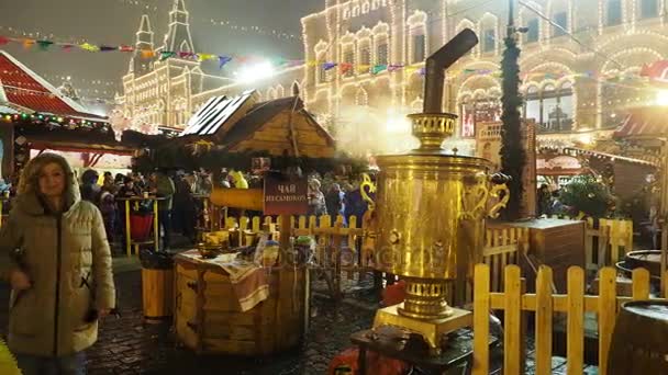 MOSCOW, RÚSSIA - 03 de dezembro de 2017: Pessoas caminhando na feira de Natal na Praça Vermelha. Café de rua com samovar dourado brilhante . — Vídeo de Stock