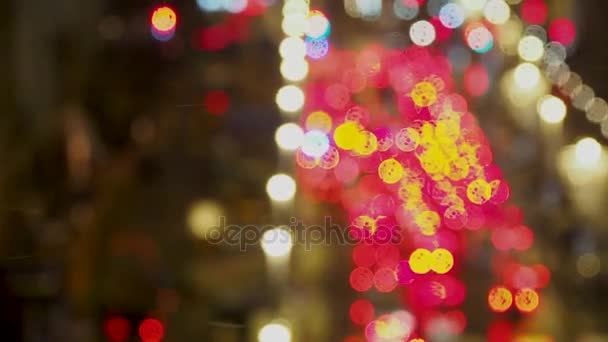 Fondo desenfocado con luces de parada de coches. Luces rojas borrosas a través de una ventana húmeda con gotas de lluvia. Tráfico de la ciudad por la noche . — Vídeos de Stock