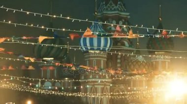 Kızıl Meydan Noel ve yeni yıl kutlama için dekore edilmiştir. Renkli bayraklar ve ampulleri, ünlü St.Basil Katedrali arka plan üzerinde. Moscow, Rusya Federasyonu.