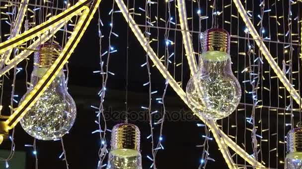 Famous Arbat street decorated for Christmas and New Year celebration. Bottom view on decorative light bulbs. Moscow, Russia. — Stock Video