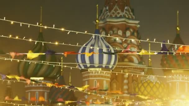 Plaza Roja decorada para la celebración de Año Nuevo y Navidad. Banderas coloridas y bombillas, famosa Catedral de San Basilio en el fondo. Moscú, Rusia . — Vídeos de Stock