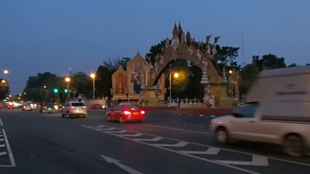 Bangkok, Thailand - oktober 20, 2012. Natt trafik på väg. Decarative traditionella gate med kungliga familj foton. — Stockvideo