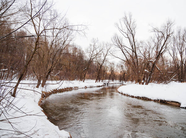 River Yauza in Losiny Ostrov National Park. Elk Moose Island in Moscow, Russia. Winter or early spring landscape.