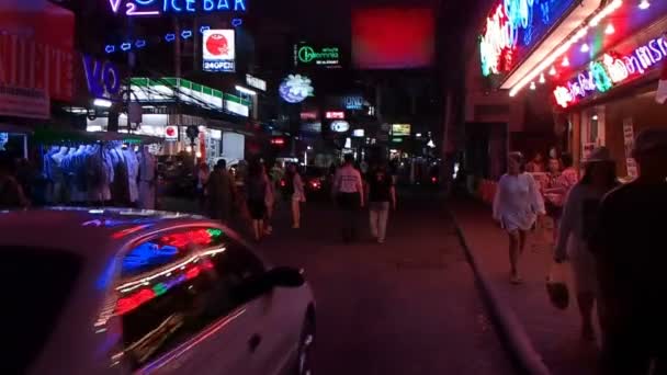 Bangkok, Thailand - 20 oktober 2012. Nachtleven op Sukhumvit road. TukTuk fietsen met kleding te koop. Verlichte advertizing reclameborden, menigte van locals en toeristen. — Stockvideo