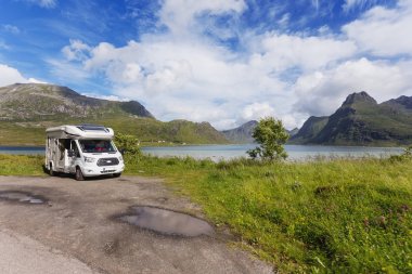 Beautiful scandinavian landscape with mountains and fjords. Car trip on camper car. Lofoten islands, Norway. clipart