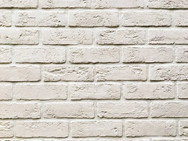 Ściana zewnętrzna z białych cegieł. Kamienna faktura budynku wal — Zdjęcie stockowe