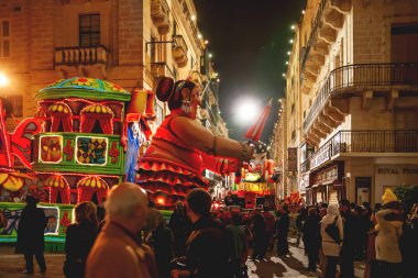 VALLETTA, MALTA - February 13, 2010. Traditional night festival. Carnival with giant moving dolls and people in colorful costumes.