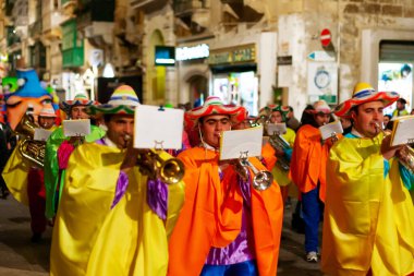 VALLETTA, MALTA - February 13, 2010. Traditional night festival. Carnival with giant moving dolls and people in colorful costumes.
