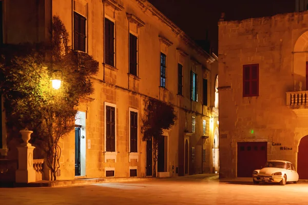 MDINA, MALTA - February 19, 2010. Illuminated streets of Mdina, ancient capital of Malta. Night view on buildings and wall decorations of ancient town.