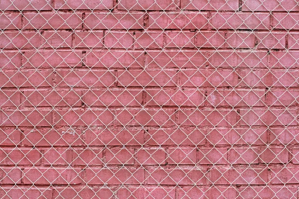 Vieux mur de briques rouges avec grille de fer comme fond ou texture — Photo