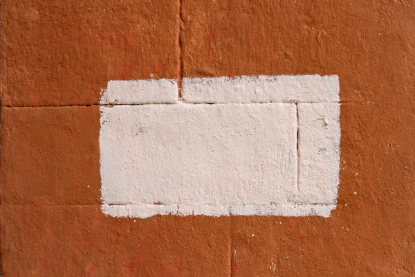 Orange concrete blocks wall with painted splotch as background or texture