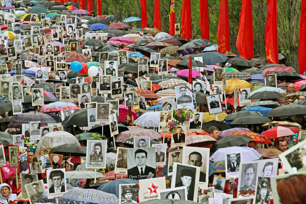 Procession of local people with photos of their relatives in Immortal Regiment on annual Victory Day on Mamaev Hill in Volgograd