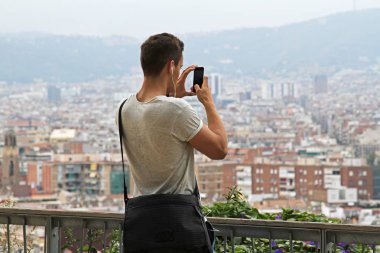 Barcelona, İspanya - 14 Eylül 2014: Arkadan görünüş adamın Barcelona görünümünü bir cep telefonu fotoğraf çekimi