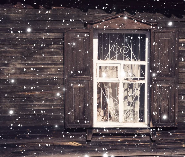 Drawing snowfall on the background of old windows, tinted
