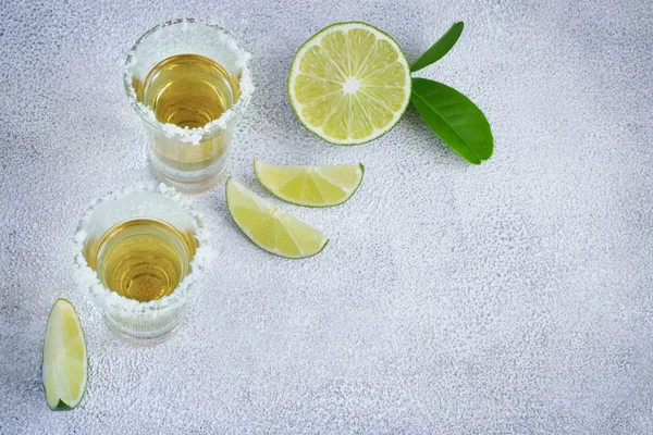 Mexican tequila gold in short glasses with salt and  lime slices