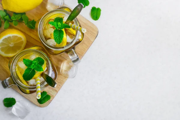 Green ice tea with lemon and mint in a glass jar. Top view with