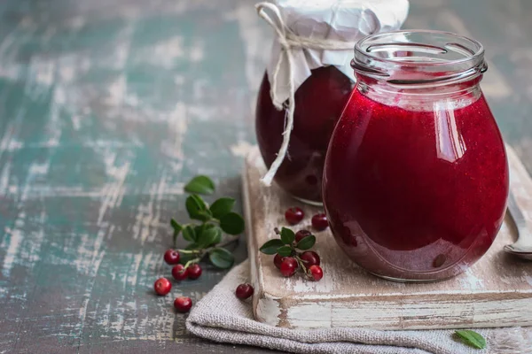 Lingonberry jam in jar and fresh berries. Selective focus, copy