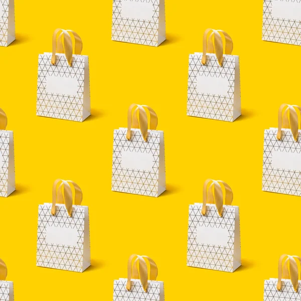 Seamless texture with White shopping bag on yellow background. Holiday sale concept, isometric view