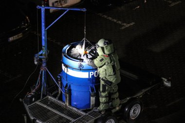 Technician of police bomb disposal unit in action