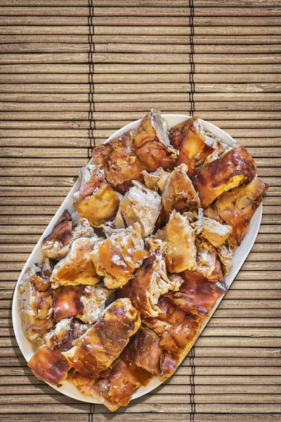 Plateful of Spit Roasted Pork Slices On Bamboo Place Mat — Stock Photo, Image
