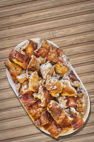 Plateful of Spit Roasted Pork Slices On Bamboo Place Mat — Stock Photo, Image