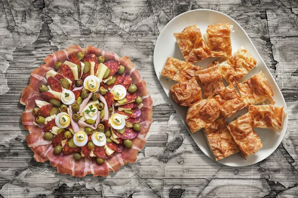 Plateful Of Appetizer Meze And Gibanica Cheese Pie On Old Cracked Flaky Wooden Garden Table — Stock Photo, Image