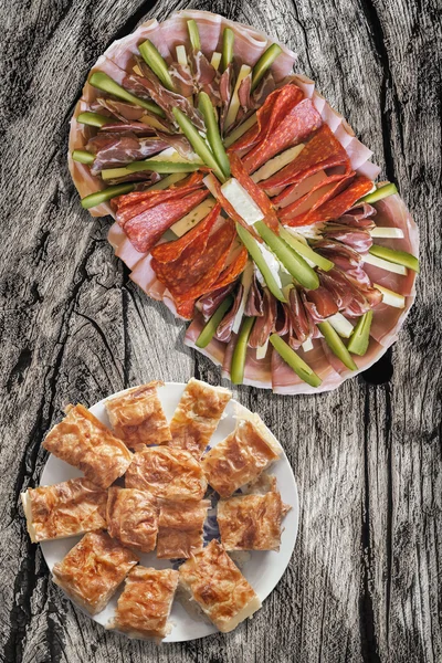 Appetizer Savory Dish Meze With Plateful Of Serbian Traditional Gibanica Crumpled Cheese Pie Set On Old Cracked Wooden Picnic Table — Stock Photo, Image