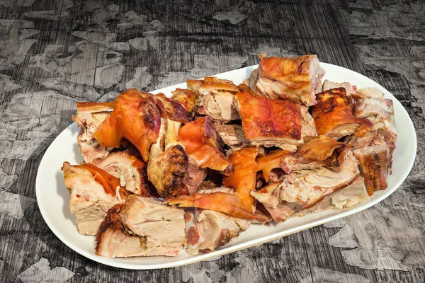 Plateful of Spit Roasted Pork Shoulder Slices Set on Old Cracked Flaky Wooden Garden Table — Stock Photo, Image