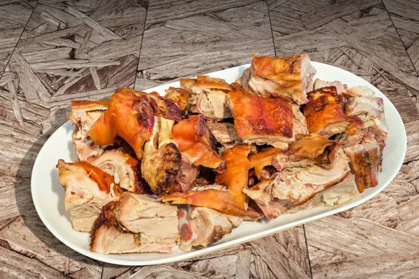Plateful of Spit Roasted Pork Shoulder Slices Set on Wooden Chipboard Rustic Grunge Table Surface — Stock Photo, Image