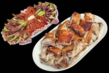 Tabak dolusu tükürük kavrulmuş domuz eti dilimleri ve siyah arka plan üzerine izole Sırp meze lezzetli yemek Meze