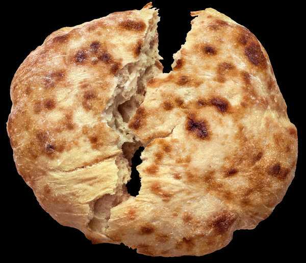 Leavened Loaf of Flatbread Torn in Half Isolated on Black Background