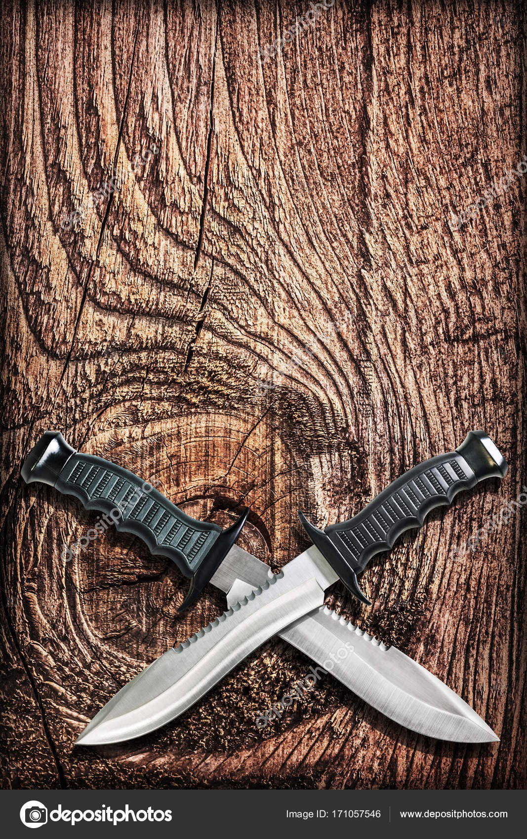 Tactical Combat Hunting Survival Bowie Knives With Crossed Blades On Grunge  Vignetted Old Battered Grooved Wood Background Stock Photo by ©Berka777  171057546
