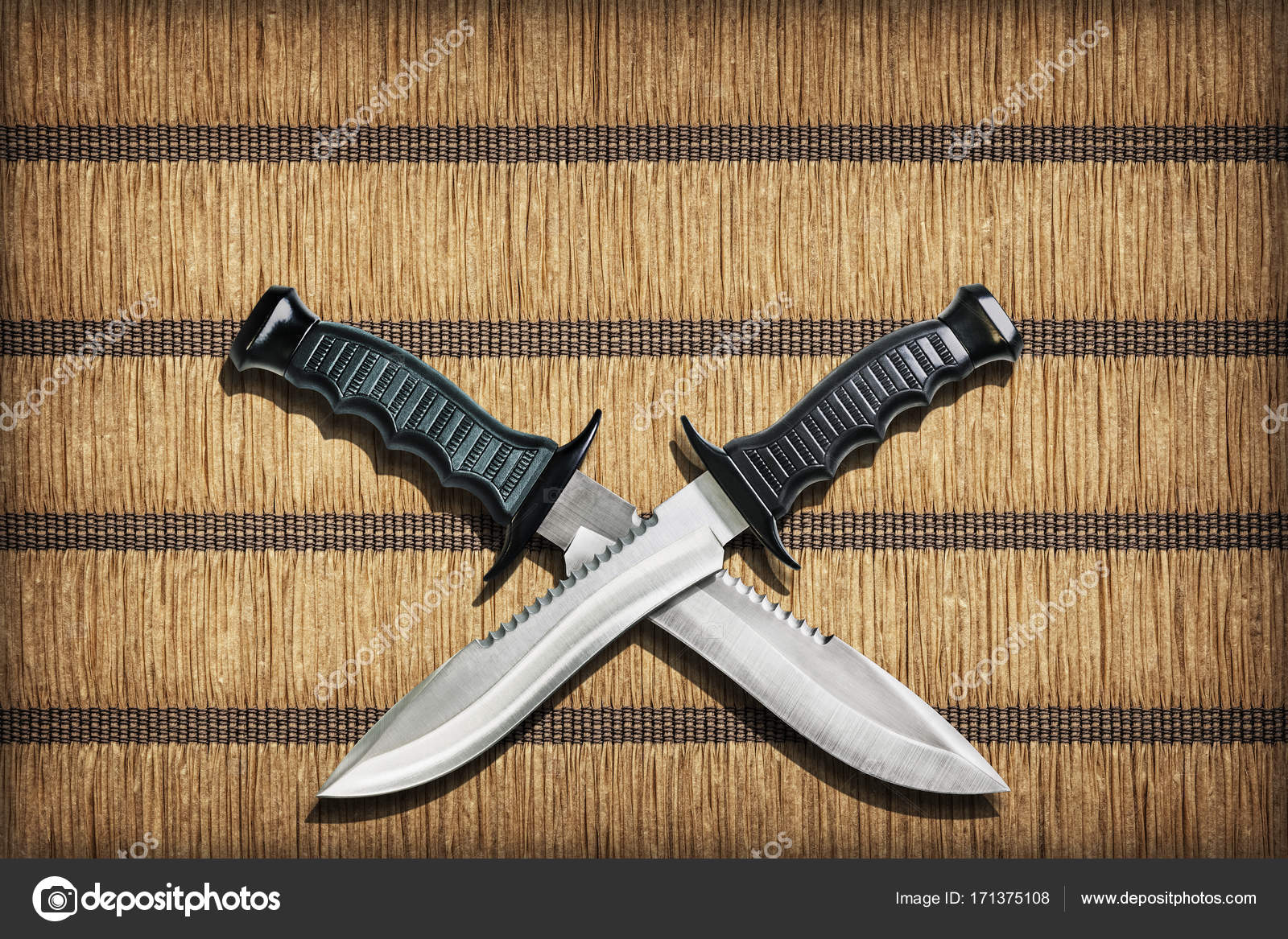 Two Crossed Blades Tactical Combat Hunting Survival Sawback Bowie Knives  Set On Yellow Plaited Paper Parchment Place Mat Vignetted Grunge Texture  Stock Photo by ©Berka777 171375108