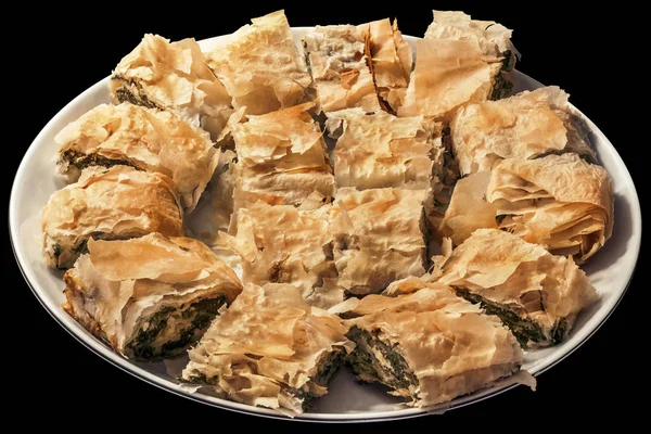 Traditional Serbian Spinach Cheese Roll Pie Offered Sliced On Round Porcelain Platter Isolated On Black Background