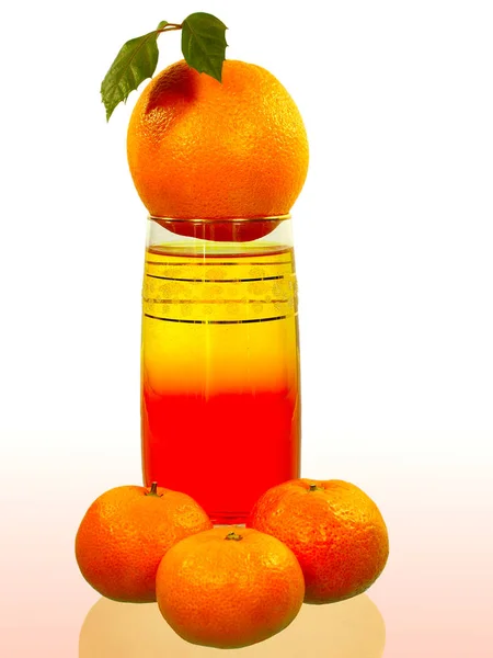 Orange is on the glass with the juice and tangerines — Stock Photo, Image