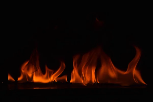 Chamas de fogo no fundo preto — Fotografia de Stock