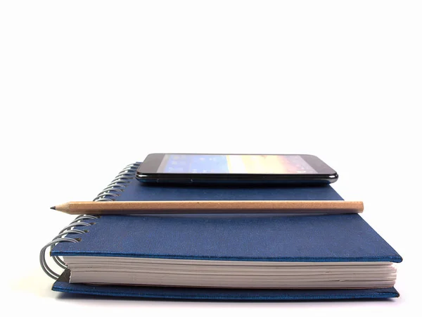 Phone and pencil placed on book. (with free space for text) — Stock Photo, Image